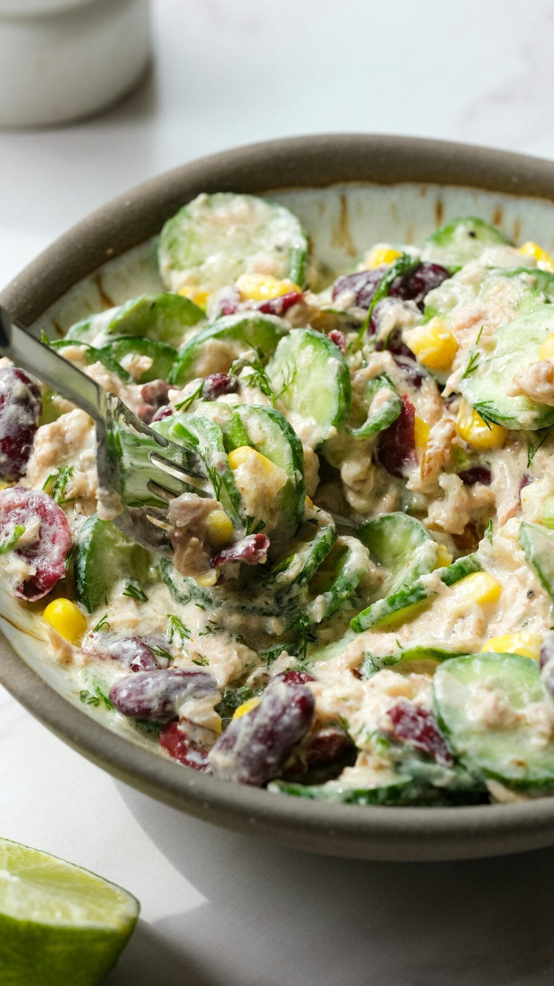 A delicious creamy vegetable and tuna salad with diverse ingredients, perfect for a healthy meal.