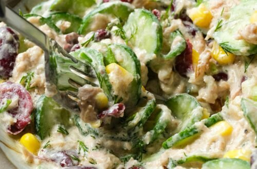 A delicious creamy vegetable and tuna salad with diverse ingredients, perfect for a healthy meal.