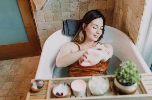 A woman enjoys a relaxing spa bath with skincare essentials, promoting self-care and wellness.