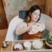 A woman enjoys a relaxing spa bath with skincare essentials, promoting self-care and wellness.
