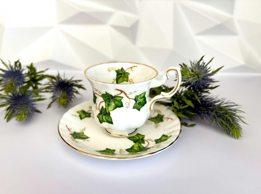 A beautifully designed teacup with an ivy motif, complemented by thistle flowers, ideal for afternoon tea settings.