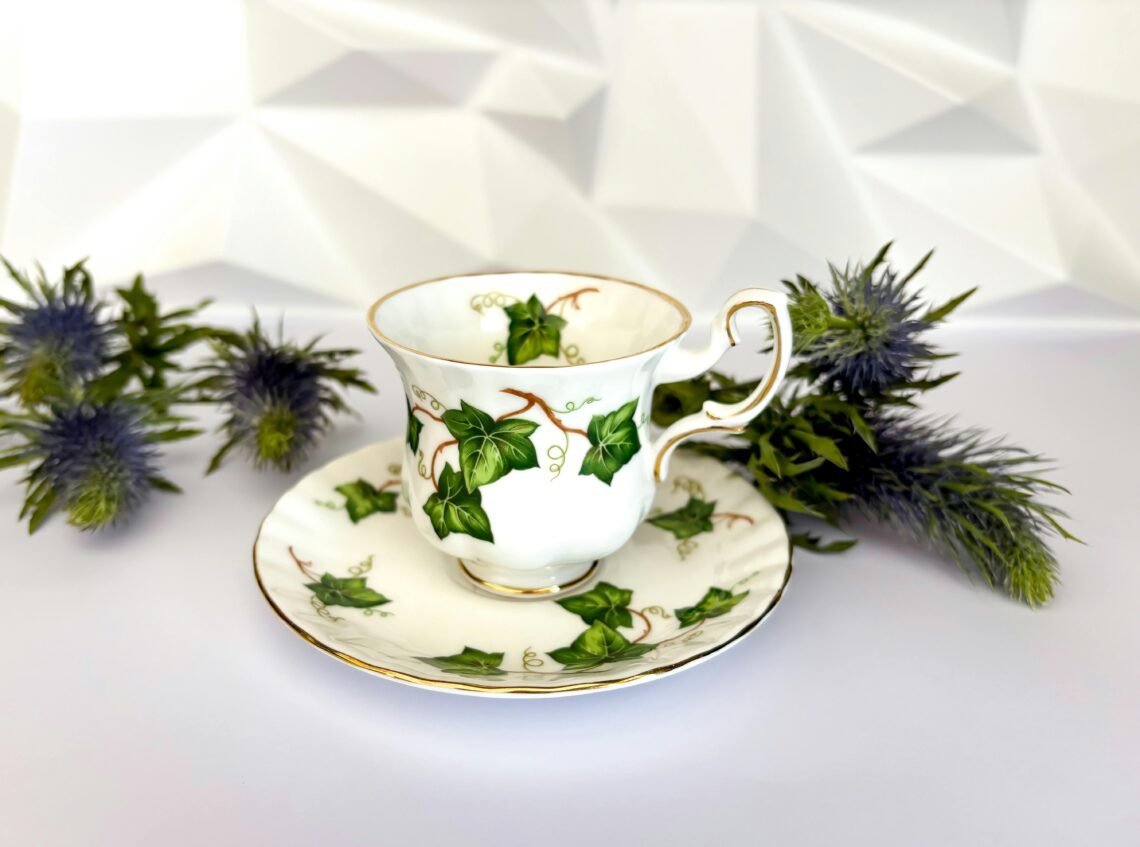 A beautifully designed teacup with an ivy motif, complemented by thistle flowers, ideal for afternoon tea settings.
