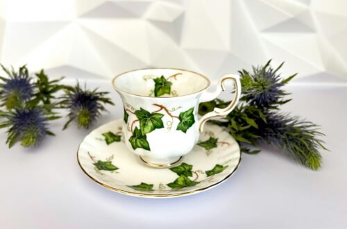 A beautifully designed teacup with an ivy motif, complemented by thistle flowers, ideal for afternoon tea settings.